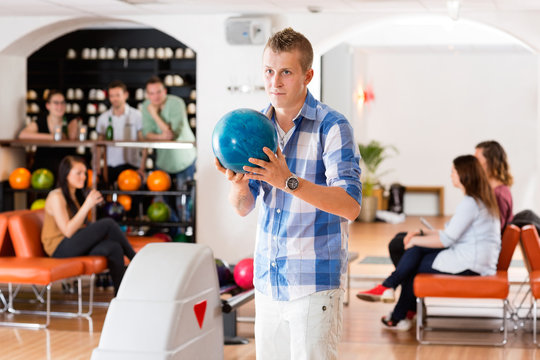 Man Ready With Bowling Ball in Club