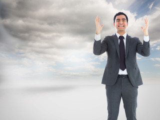 Composite image of stressed businessman with arms raised