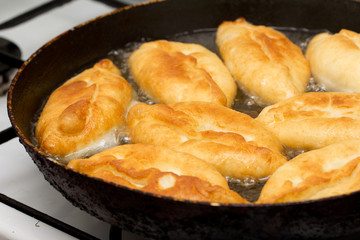 patties are fried in a pan
