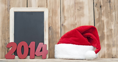 Obraz na płótnie Canvas blackboard witn number 2014 with santa hat