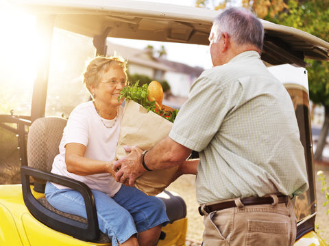 Elderly Couple Bringing Home Groceries