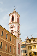Fototapeta na wymiar Pink Clock Tower on Yellow Plaster Building