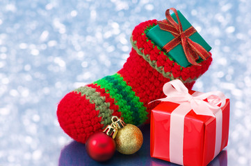 Small Christmas stocking and presents on white sparkle backgroun
