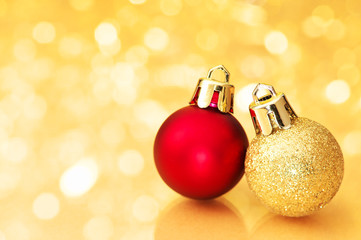 Christmas balls on gold sparkle background.