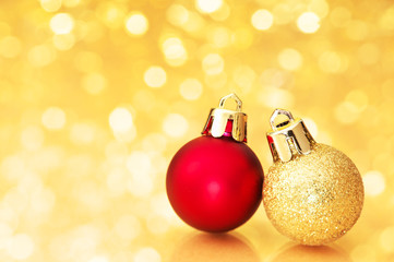 Christmas balls on golden defocused lights background.