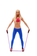 Cute aerobics instructor posing with skipping rope