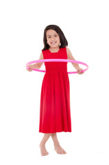 Young girl playing with hula hoop isolated over white background