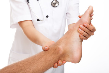 Physician examining painful foot