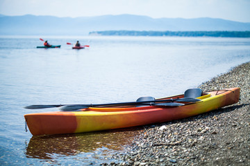 Kayak on the Sea Shore with Kayakers in the Background