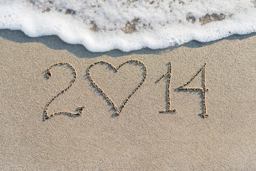 Happy New Year 2014 on the sea sandy beach with heart, love conc
