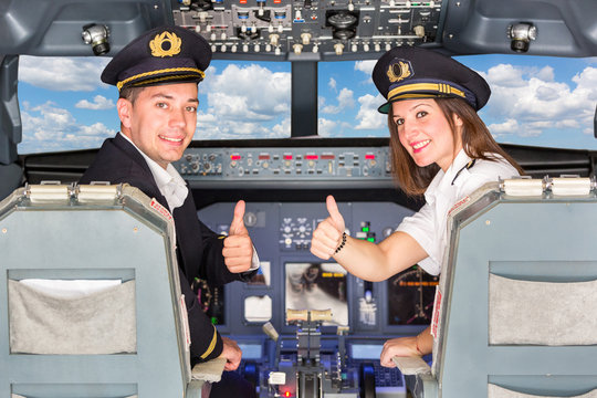 Happy Pilots in the Cockpit with Thumbs Up