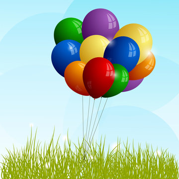 Bunch of full-color balloons on green grass