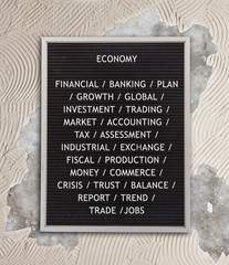 Economy concept in plastic letters on very old menu board