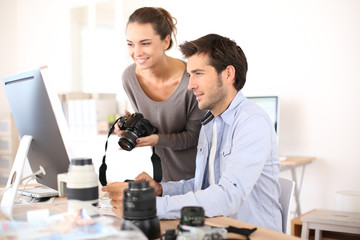 Photo reporters working in office