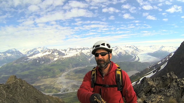 Male Mountain climber filming selfie achievements, Alaska, USA