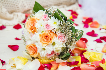 Bridal wedding bouquet of flowers with rose petals
