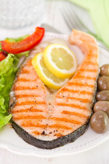 grilled fish with salad and olives