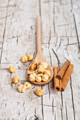hazelnuts in wooden spoon and sinnamon sticks