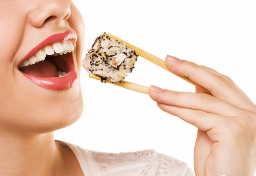 Beautiful Young Woman Eating Sushi