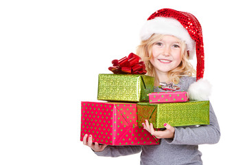 Child holding a stack of Christmas presents