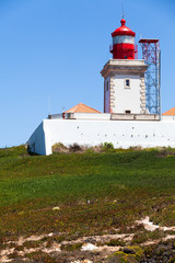 Fototapeta na wymiar Lighthouse on top of hill in Cabo da Roca.