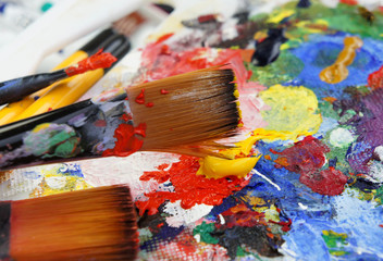 Fototapeta premium Art palette and mix of paintbrushes