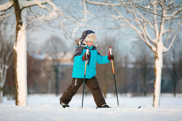 Cute little boy skiing on cross