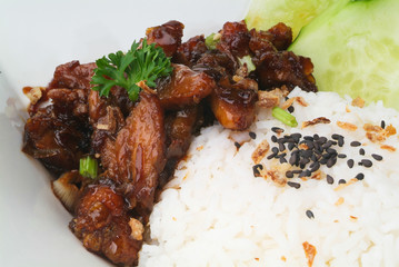 Chicken with rice and vegetables in background
