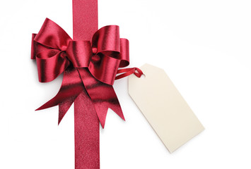 Red ribbon bow with blank gift tag