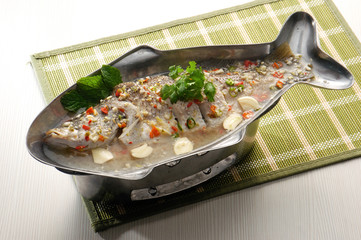 Steamed fish asia style on background