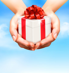 Holiday background with hands holding gift boxes. Concept of giv