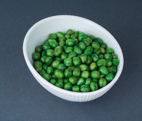 Nuts in bowl on grey background.