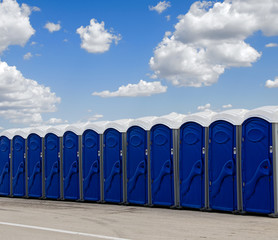 A row of blue portable toilets