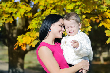 little boy with his mother in autumn park