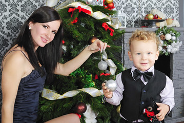 the little boy next to the Christmas tree with my mother in a su