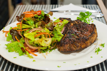 T-bone steak with salad.