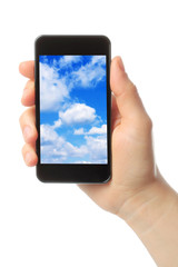 Woman hand holds smart phone with sky 