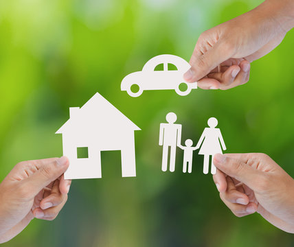 Hand holding a paper home, car, family, insurance concept