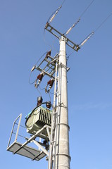 Electric pole with a transformer on a background of blue sky