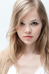Portrait of a beautiful young girl on a white background
