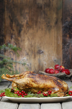 Baked Goose On Wooden Table. Popular Christmas Dish