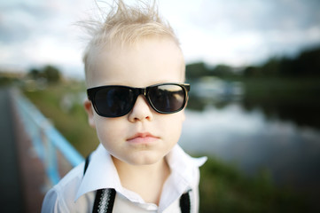 Fototapeta na wymiar little gentleman with sunglasses outdoors