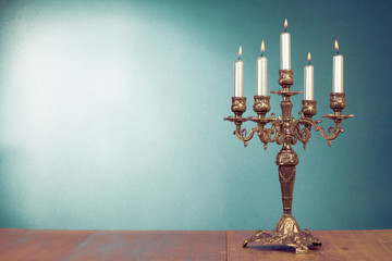 Vintage bronze candlestick with five burning candles