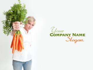Woman presenting a bunch of carrots