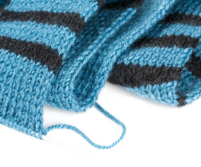 striped scarf on knitting needles