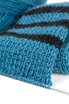 striped scarf on knitting needles