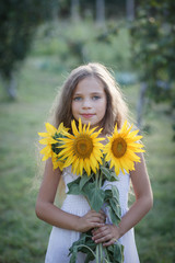 Young pretty woman on a sunflowers