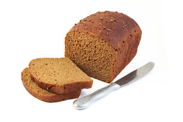 Loaf of rye bread with slices and knife