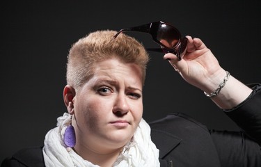 Portrait of Chubby woman with short hair and sunglasses
