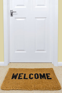 Welcome Doormat Outside A Door.